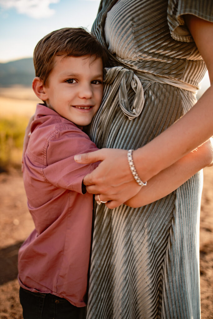 Son hugging his mom's waist.