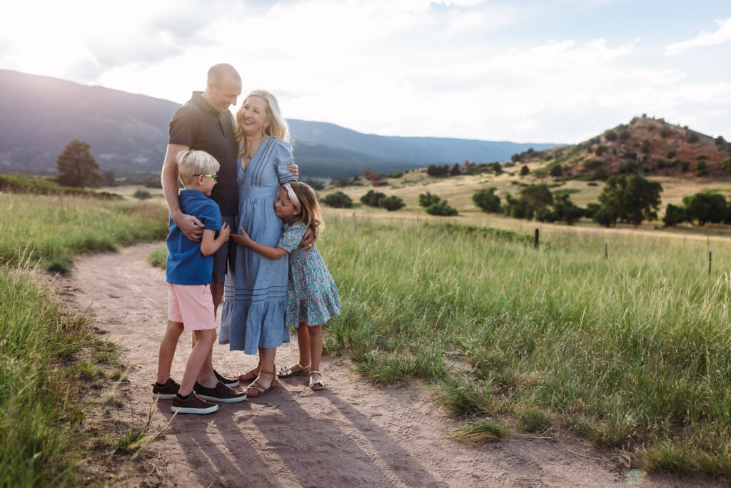 Family snuggling on a trail in Colorado Springs.