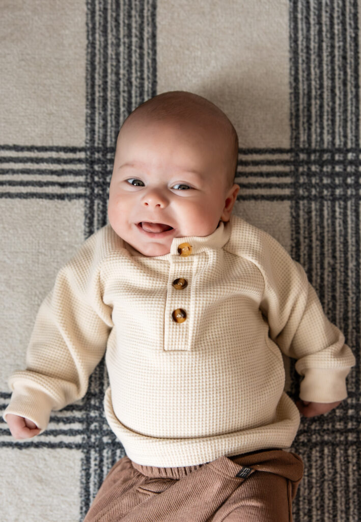 Newborn baby smiling at newborn photo session near Colorado Springs.