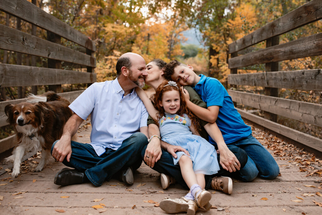 Family posing on a bridge in a beautiful location in Colorado Springs.