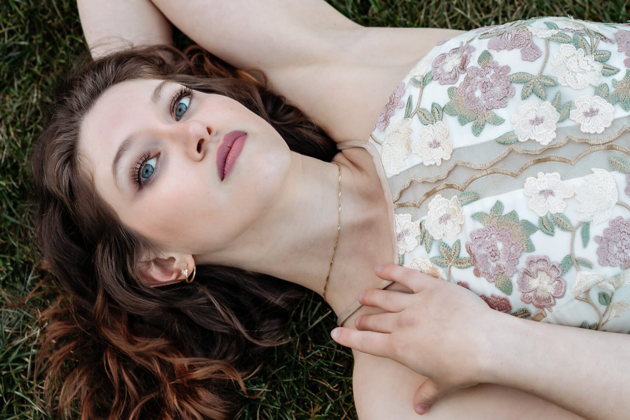 High school senior posing on grass in Colorado Springs.